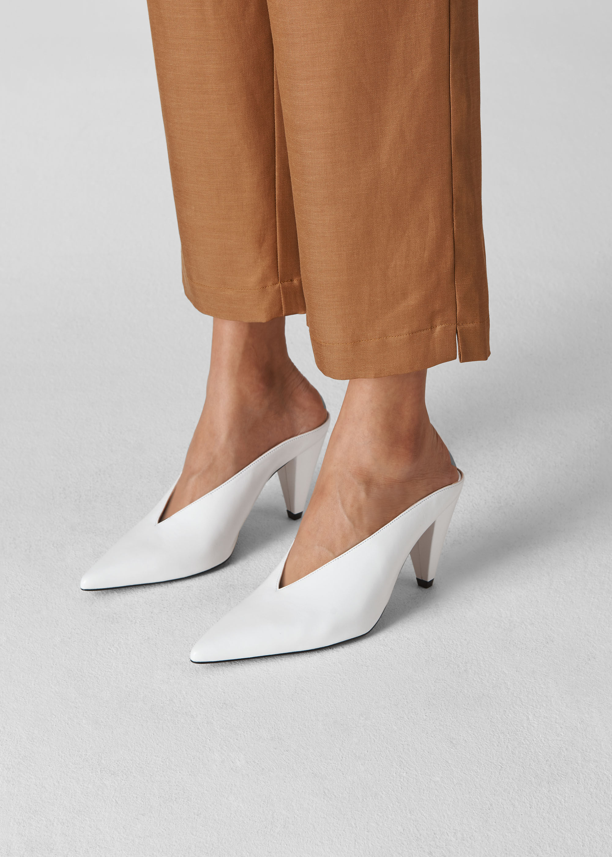 White pointed shop mules