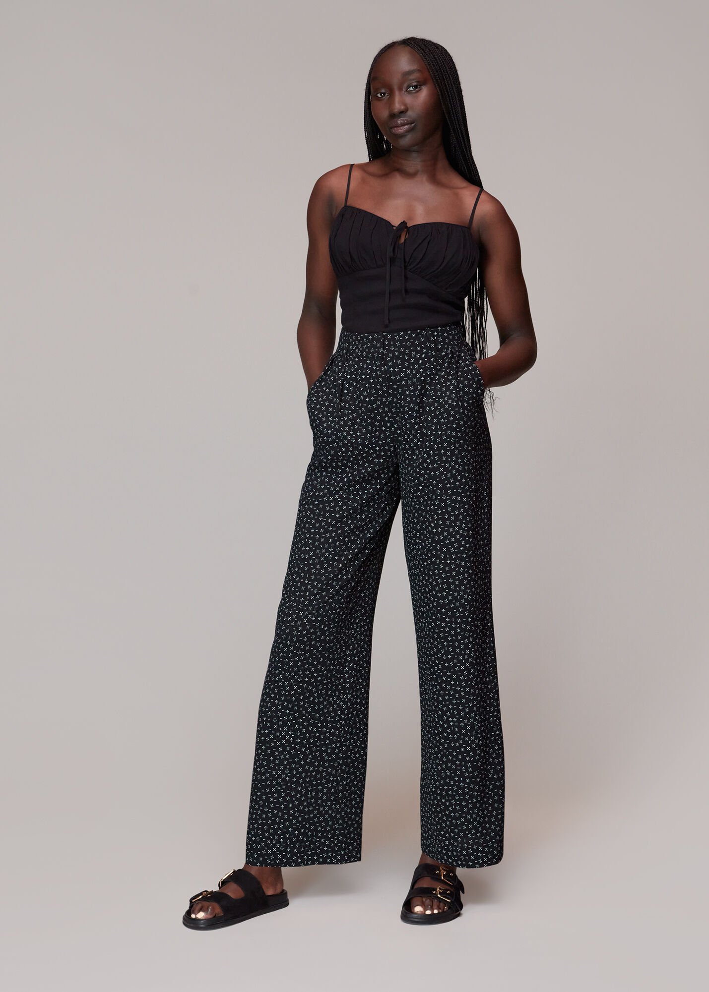 White pants with store black polka dots