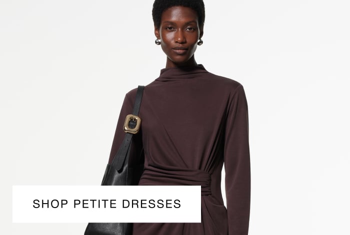 Woman wearing Whistles' chocolate-brown maxi dress with a twist-ruched waist, long sleeves, and a black leather shoulder bag