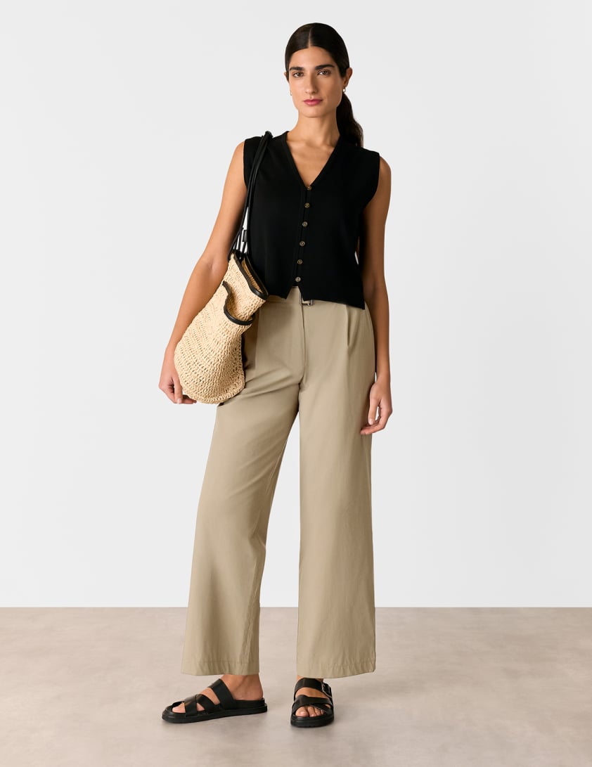 woman wearing taupe trousers with black knitted tank