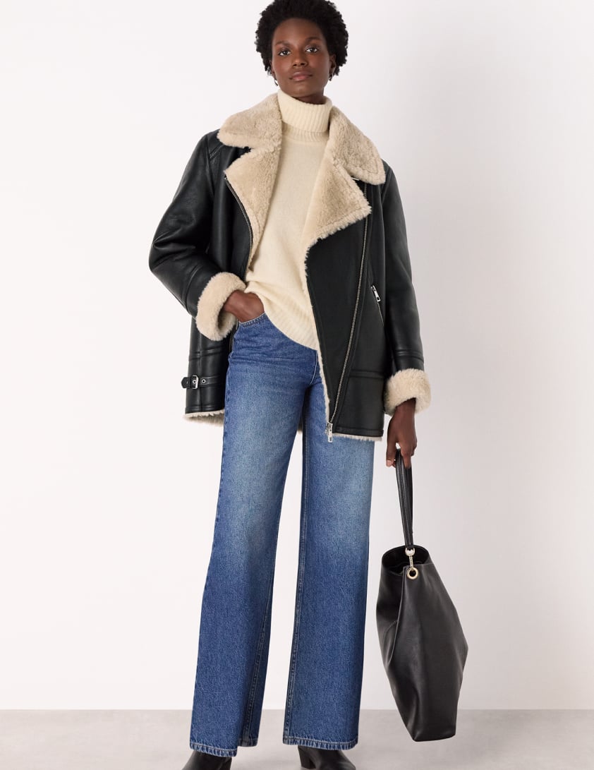 woman wearing shearling leather jacket with jeans