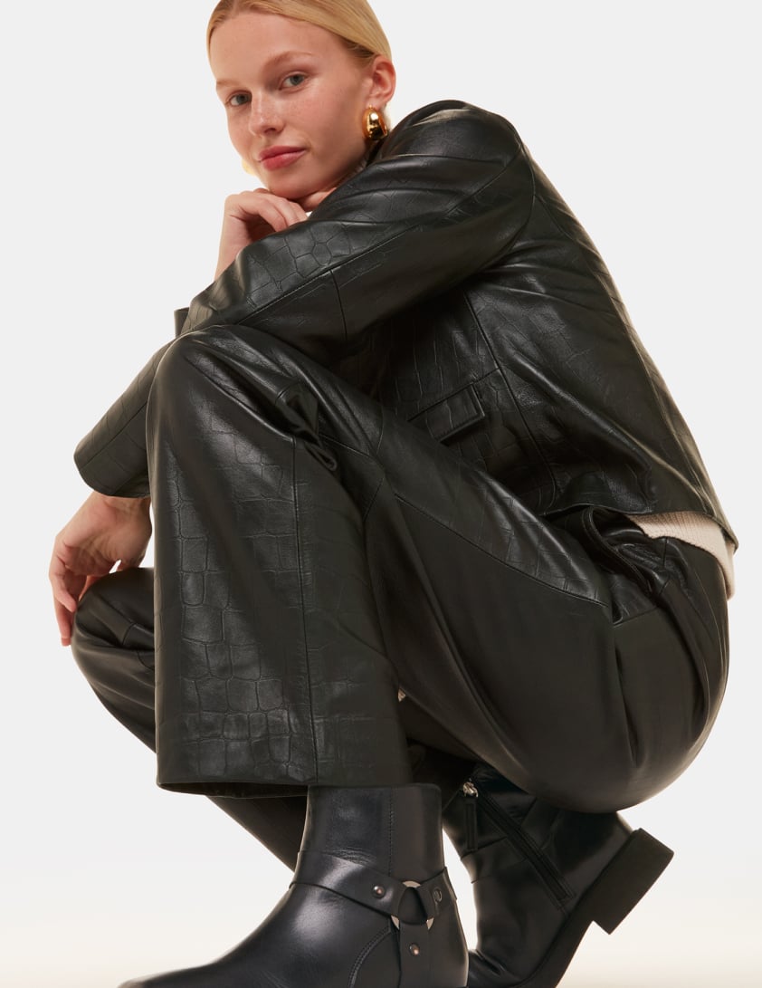 woman wearing black leather boots