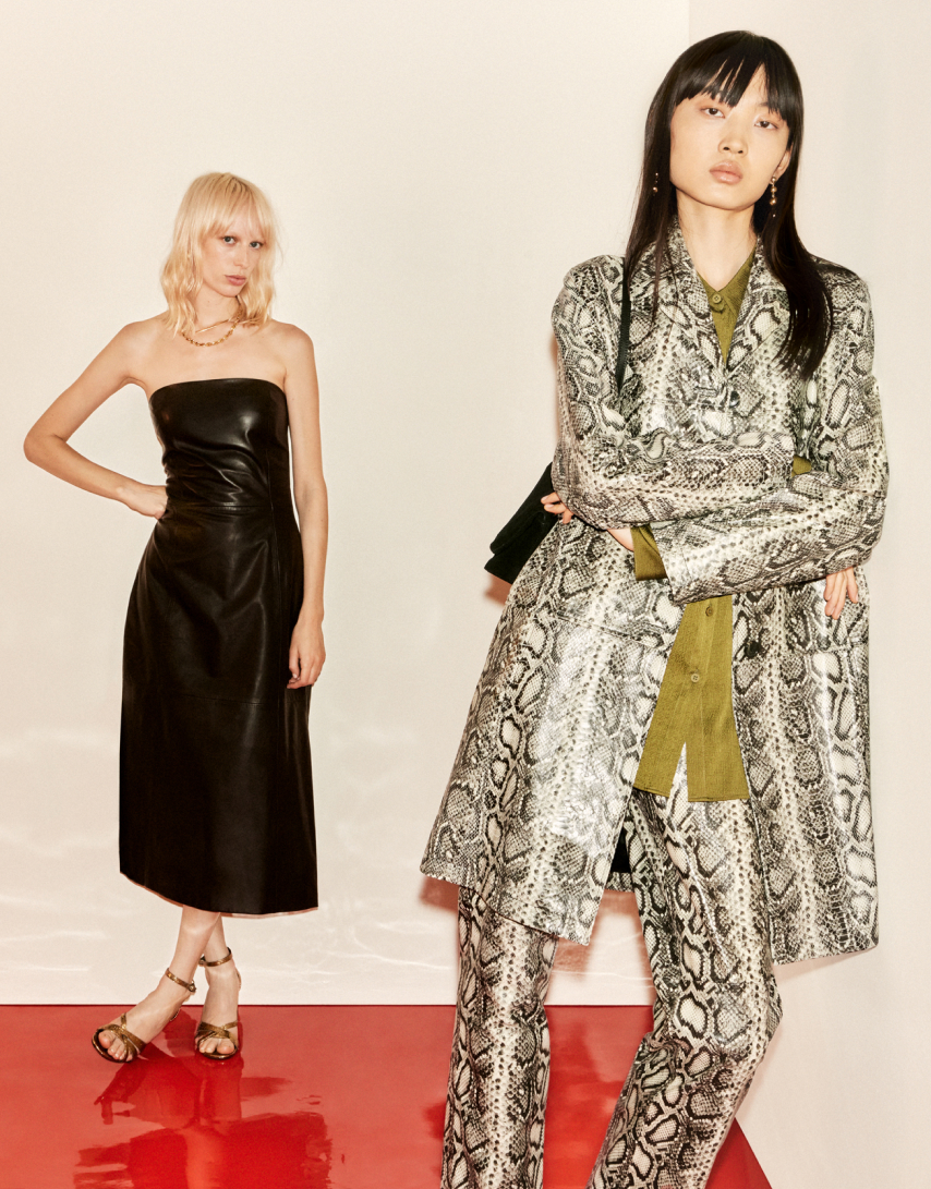two Women wearing, one wearing a dress and the other wearing snake print jackect and trousers