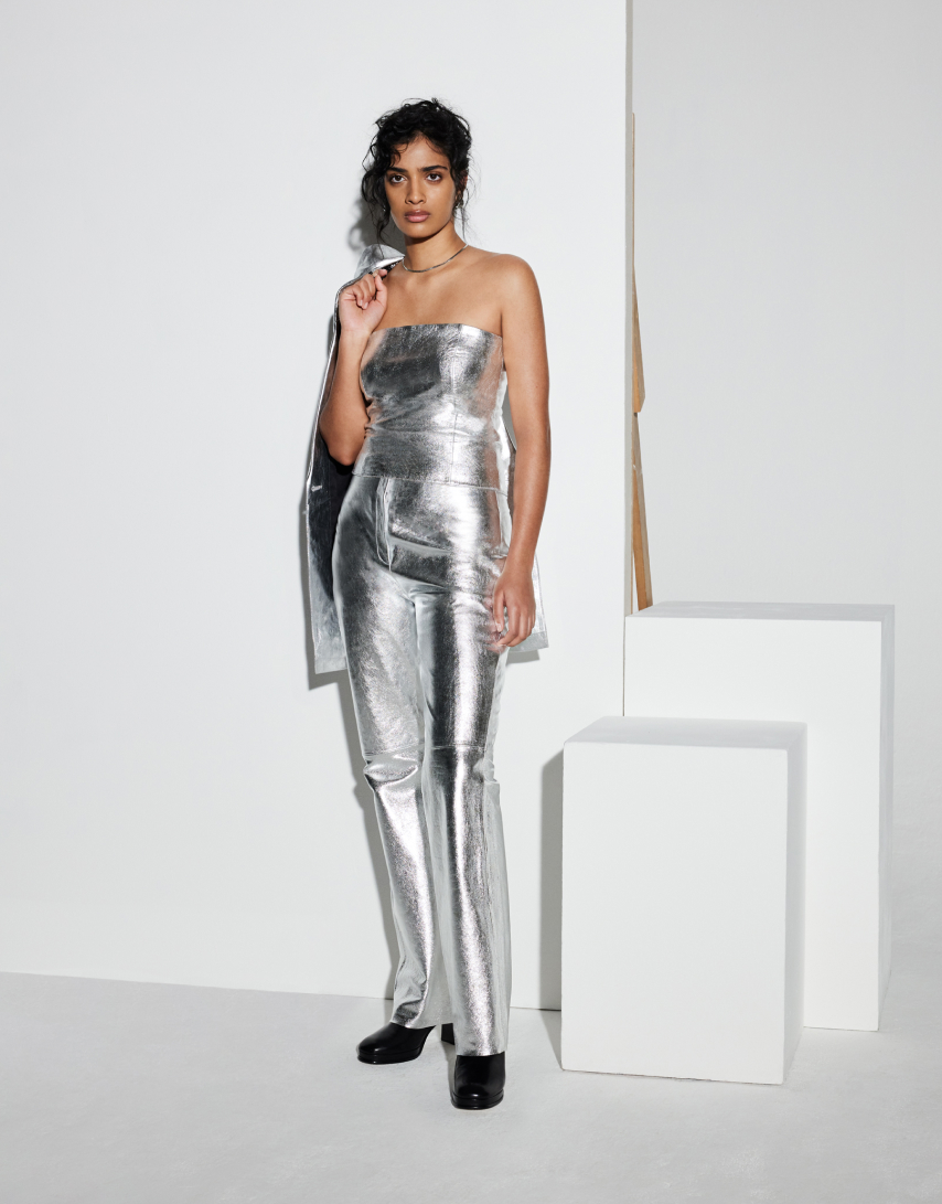 womnan wearing sliver bandu top and sliver trousers
