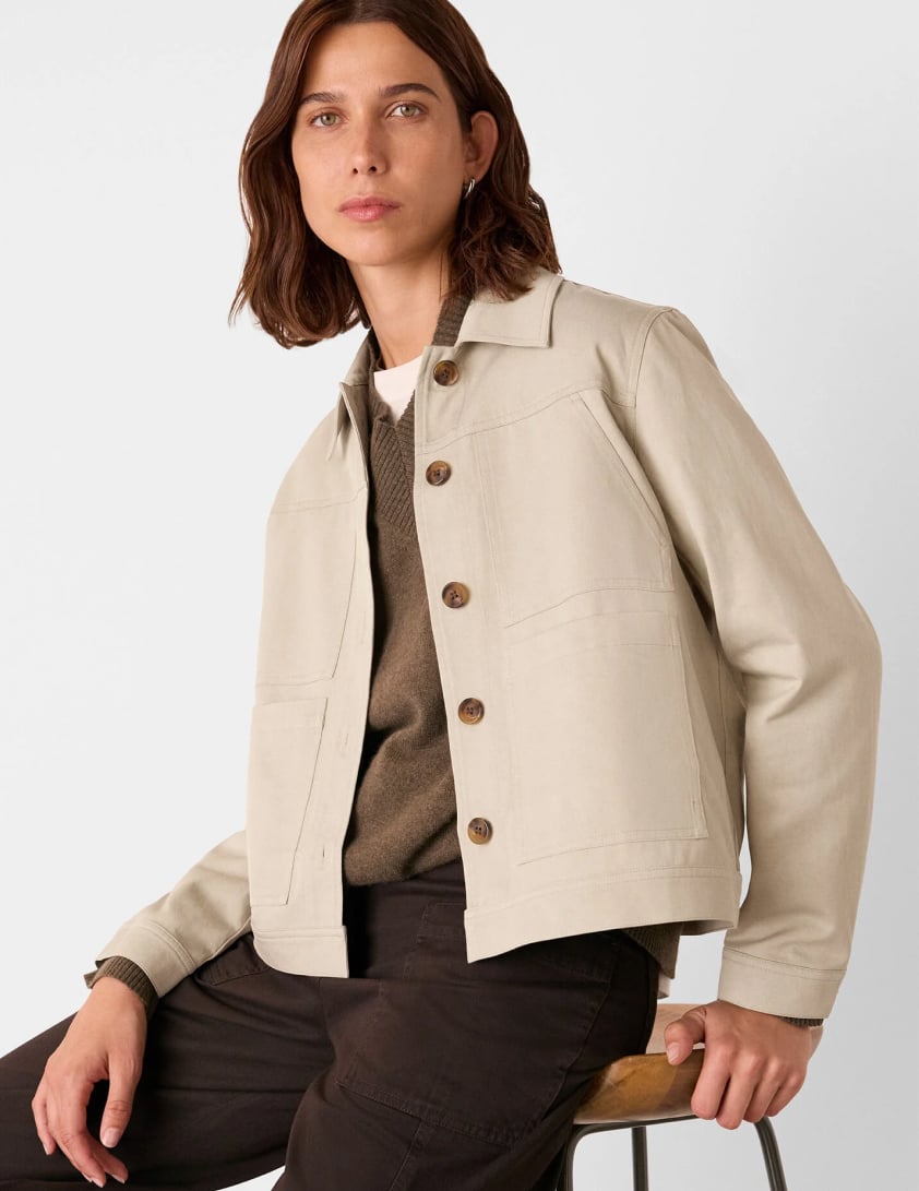 Woman wearing a cream utility style jacket with chest pockets layered for Whistles 15% off everything promotion