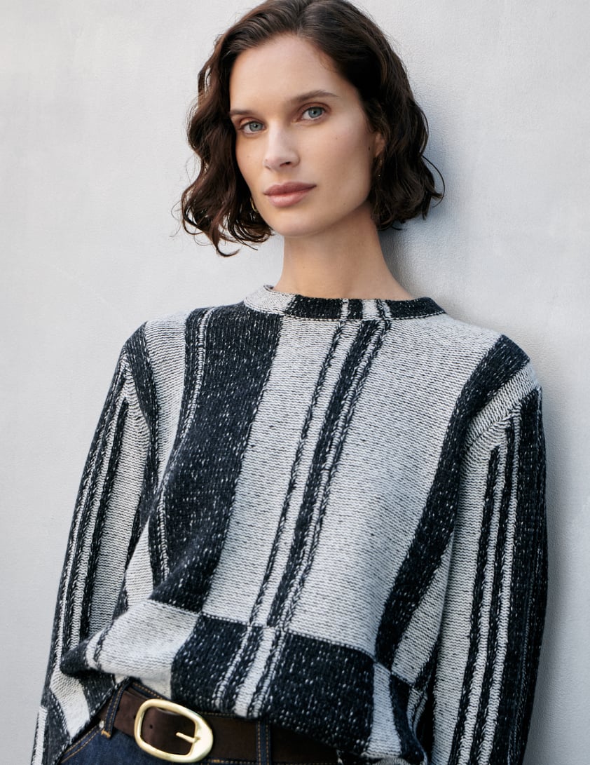 Woman wearing black and grey jumper