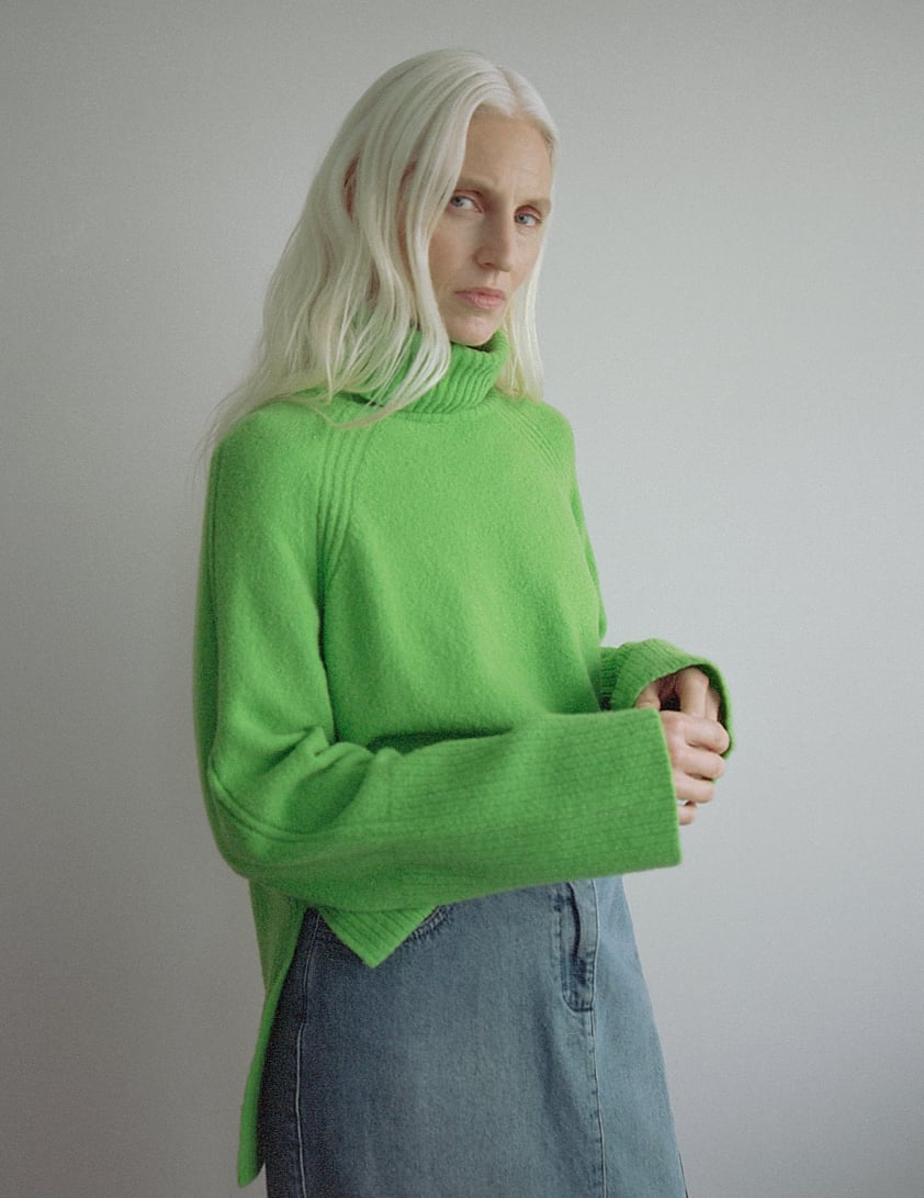 woman wearing bright green jumper