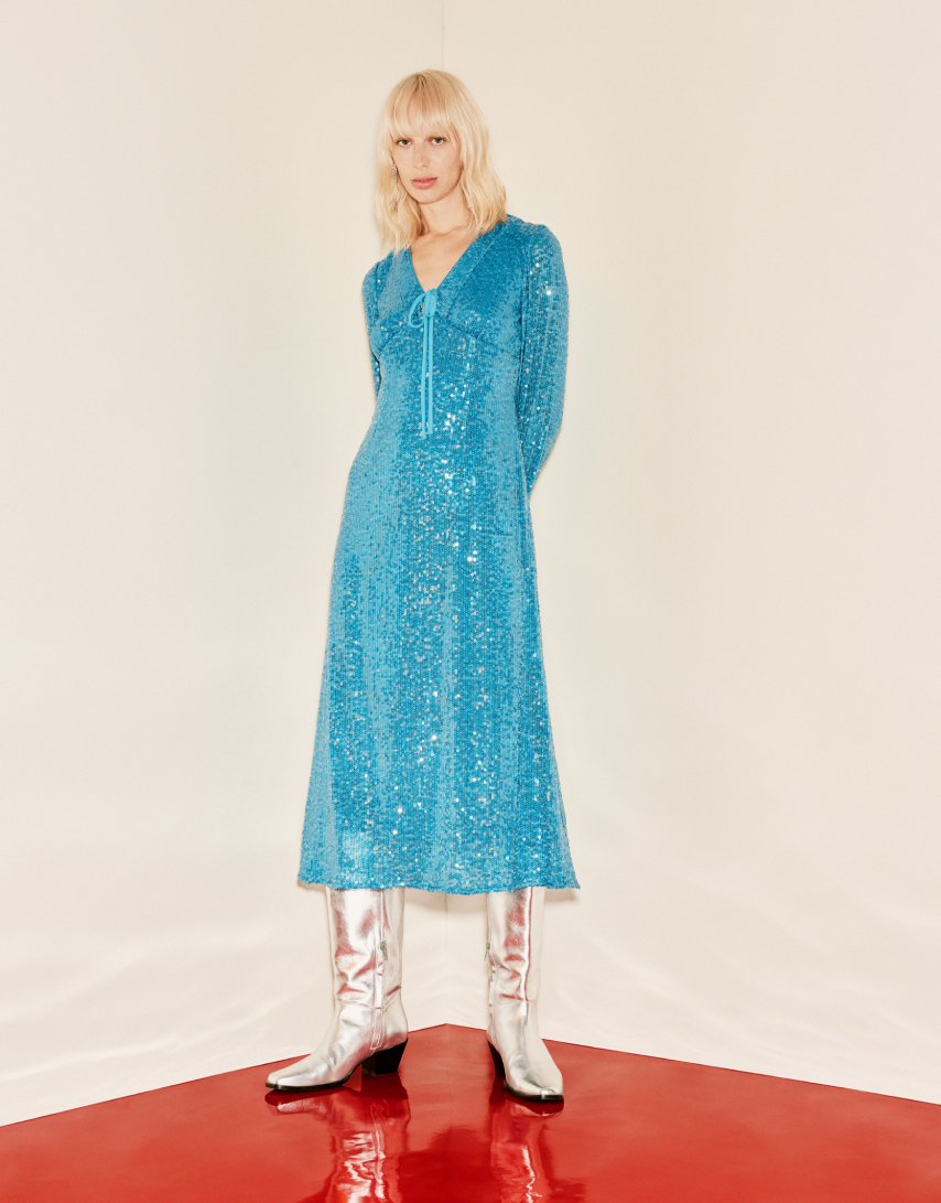 two Women wearing, one wearing a dress and the other wearing snake print jackect and trousers