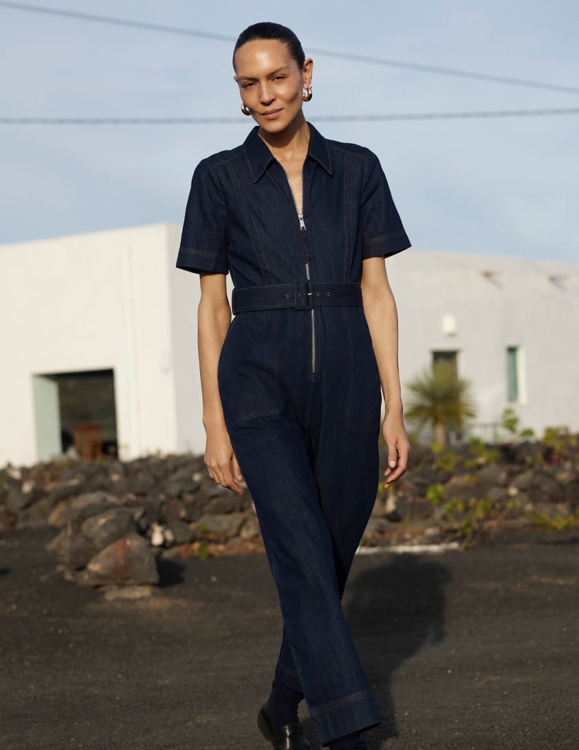 woman waering dark denim jumpsuits 
