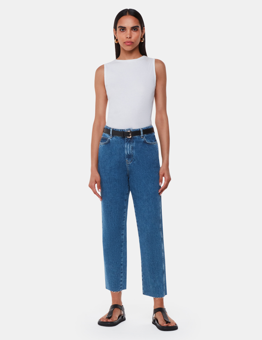 woman wearing blue jens and white top